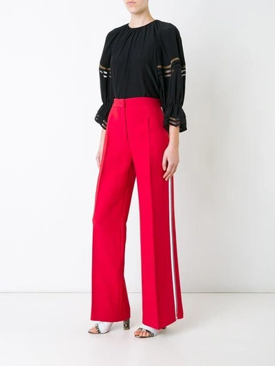 Shop Fendi Side Stripe Flared Trousers In Red