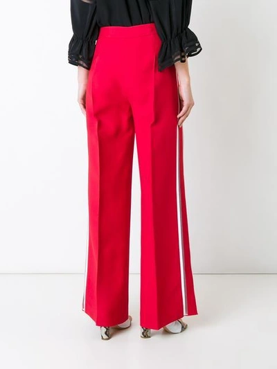 Shop Fendi Side Stripe Flared Trousers In Red