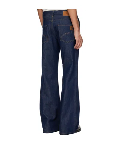 Amiri Raw Boot Cut Jeans In Blue