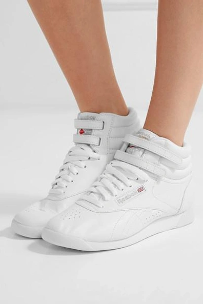 Shop Reebok Freestyle Leather High-top Sneakers