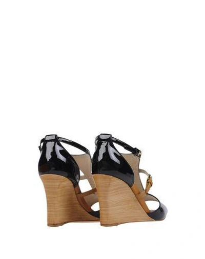 Shop Tod's Sandals In Black