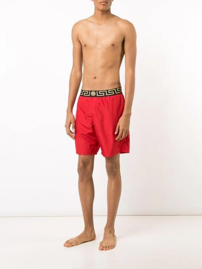 Shop Versace Iconic Greca Medusa Swim Shorts In Red