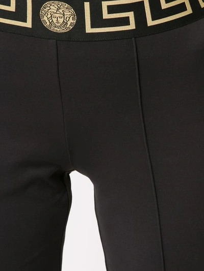 Shop Versace Greek Key Waistband Flared Leggings In Black