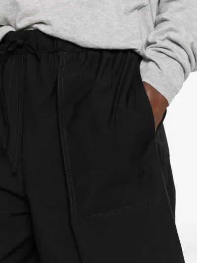 Totême Drawstring Patch-pocket Trousers In Black