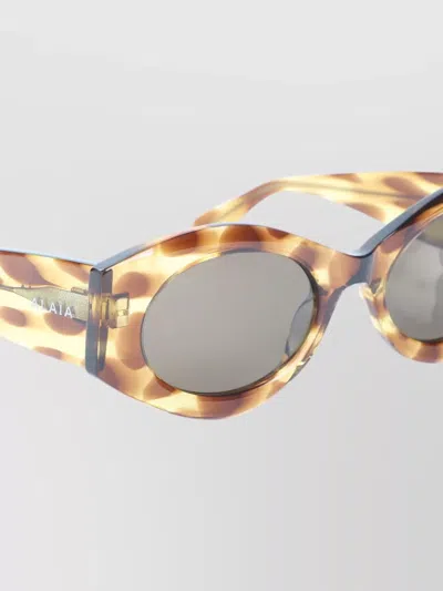 Alaïa Acetate Oval Frame Patterned Sunglasses In Brown