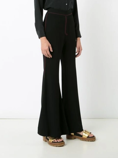 Shop Ellery Flared Stitched Trousers In Black
