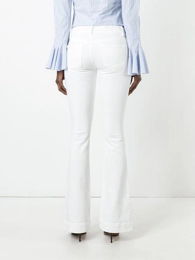 Shop J Brand Flared Low-rise Jeans In White