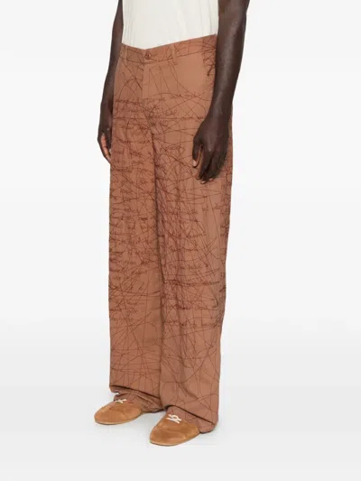 Kidsuper Embroidered Scribble-pattern Trousers In Brown