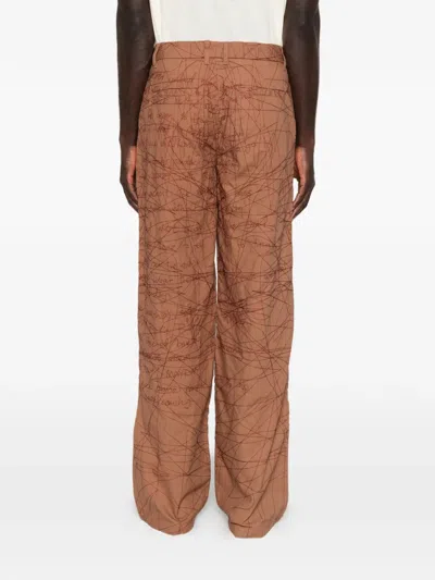 Kidsuper Embroidered Scribble-pattern Trousers In Brown