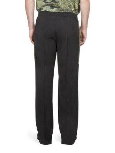 Shop Givenchy Solid Jogger Trousers In Black