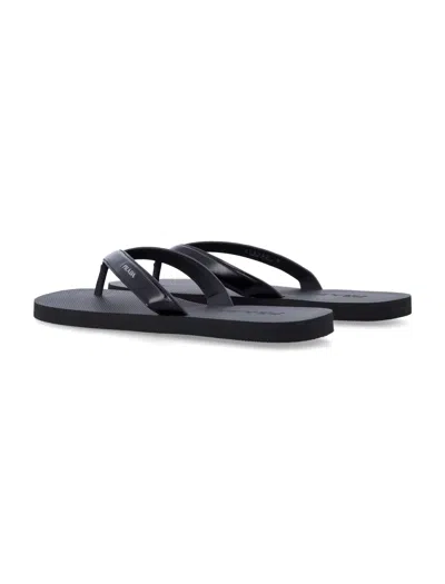 Prada Logo Embossed Leather Flip Flop Sandals In Black