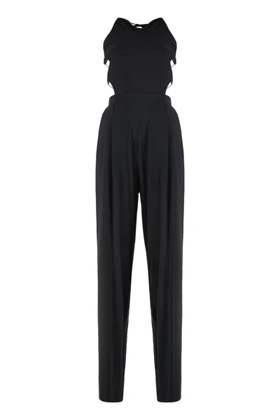 Amazuìn Sleek Elasticated Jumpsuit With Open Back And Draped Legs In Black