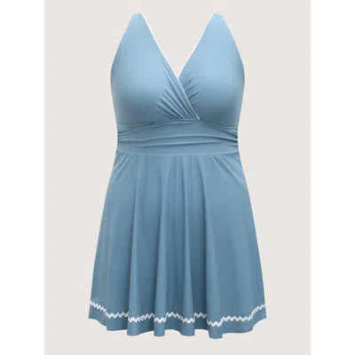 Bloomchic Solid Webbed Surplice Swim Dress In Blue