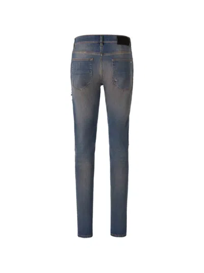 Amiri Distressed Ribbed-panel Jeans In Blue
