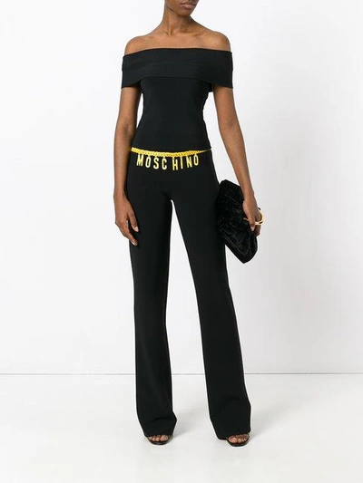 Shop Moschino Printed Logo Chain Trousers In Black