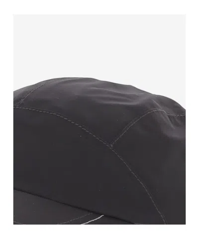 And Wander Drawstring Hat In Black
