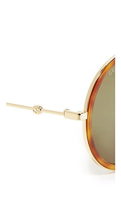 Shop Gucci Urban Web Block Round Aviator Sunglasses In Gold/green