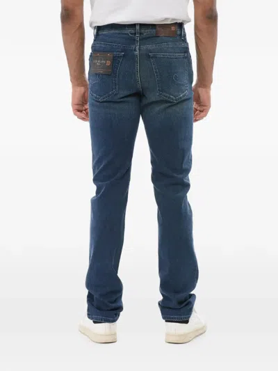 Corneliani Logo-embroidered Washed Jeans In Blue