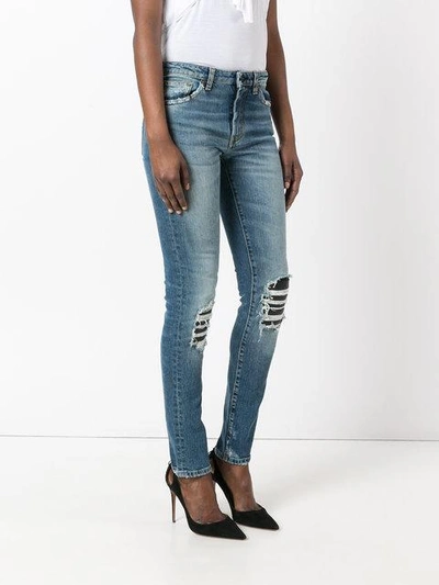 Shop Saint Laurent Ripped Detail Jeans In Blue