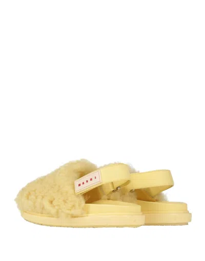 Marni Shearling And Leather Mules In Yellow