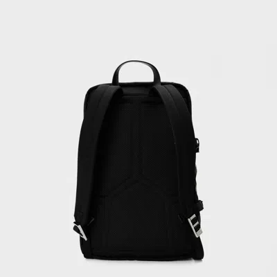 Prada Triangular Logo Backpack In Blue