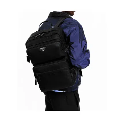 Prada Triangular Logo Backpack In Blue