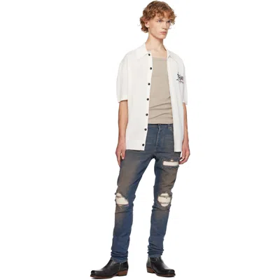 Amiri Distressed Ribbed-panel Jeans In Blue