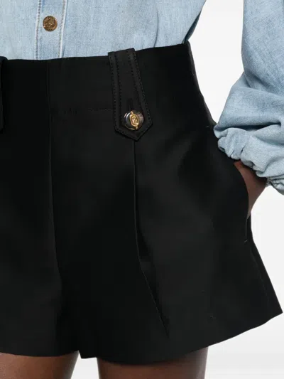 Zimmermann Valiant Tailored Button-embellished Pleated Shorts In Black