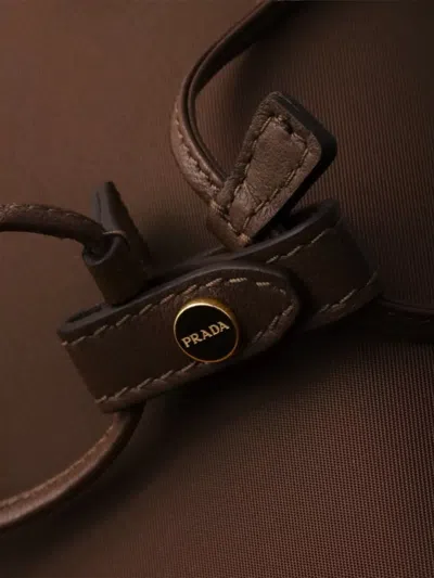 Prada Re-nylon Drawstring Bucket Bag In Brown