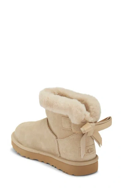 Ugg ® Mini Bailey Bow Faux Shearling Boot In Mustard Seed