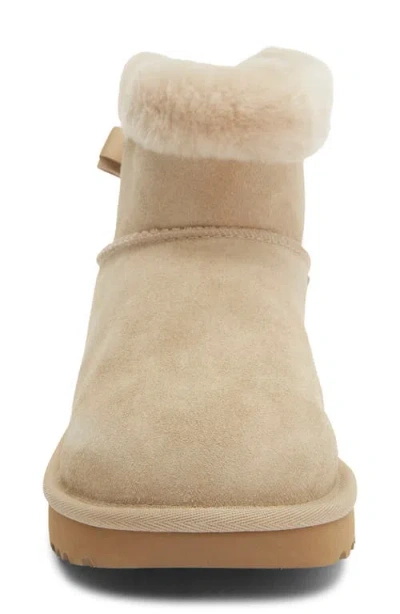Ugg ® Mini Bailey Bow Faux Shearling Boot In Mustard Seed