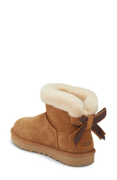 Ugg ® Mini Bailey Bow Faux Shearling Boot In Chestnut