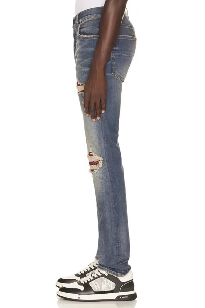 Amiri Distressed Patchwork Jeans In Blue