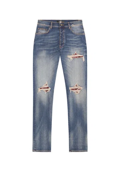 Amiri Distressed Patchwork Jeans In Blue