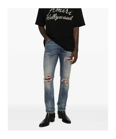 Amiri Distressed Patchwork Jeans In Blue