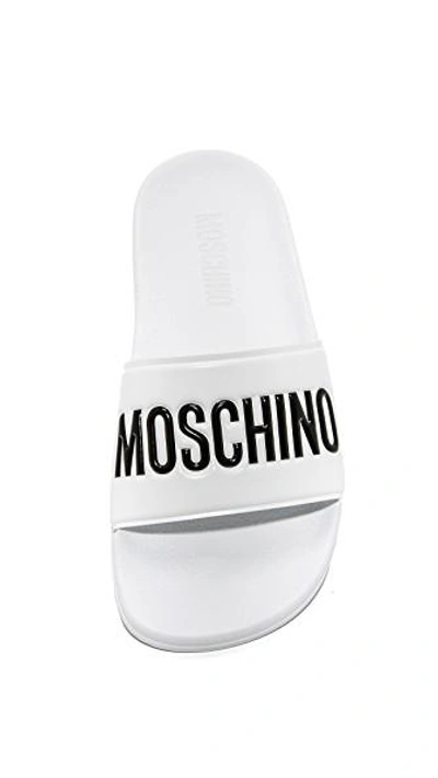Moschino Embossed Logo Pool Slides In White/black