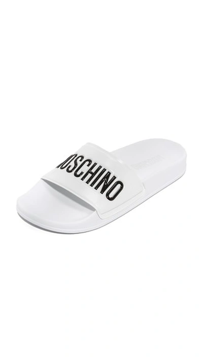 Shop Moschino Sandals In White/black