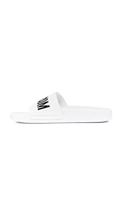 Moschino Embossed Logo Pool Slides In White/black
