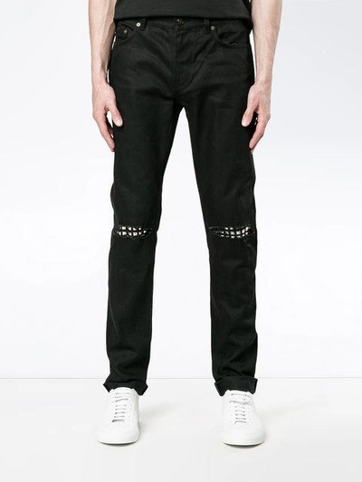 Shop Saint Laurent Ripped Stud Slim Fit Jeans In Black