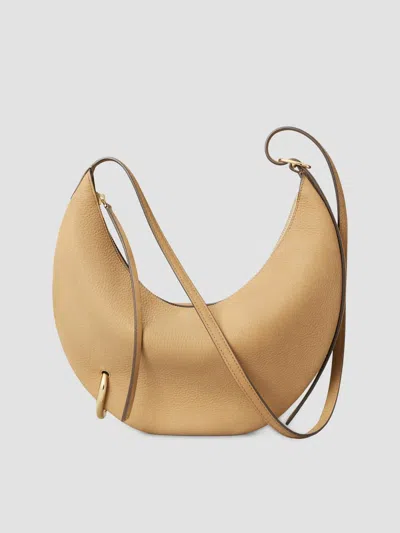 Tory Burch Pierced Leather Crossbody In Stone