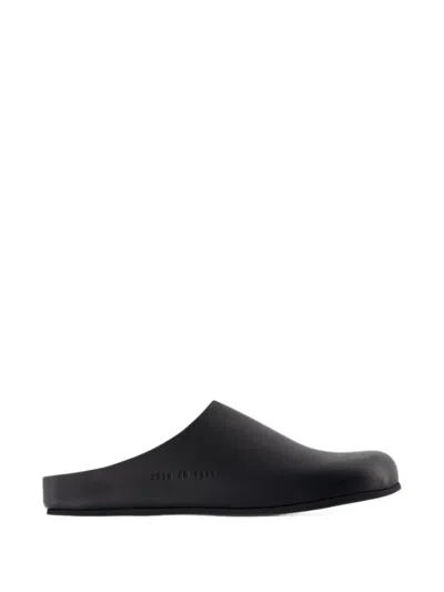 Common Projects Logo-debossed Suede Clogs In Black