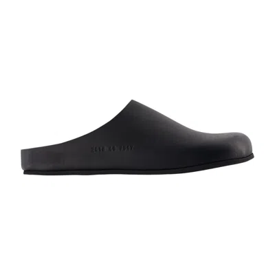 Common Projects Logo-debossed Suede Clogs In Black