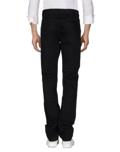 Shop Valentino Denim Pants In 黑色