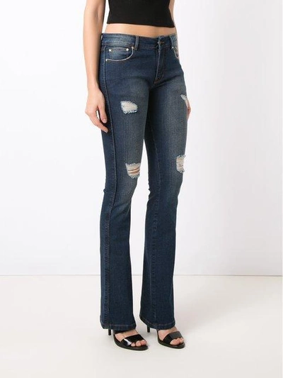 Shop Amapô Distressed Flared Jeans In Blue