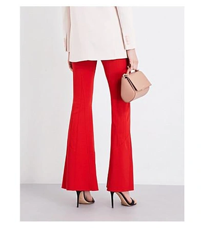 Shop Givenchy Flared Mid-rise Woven Trousers In Red