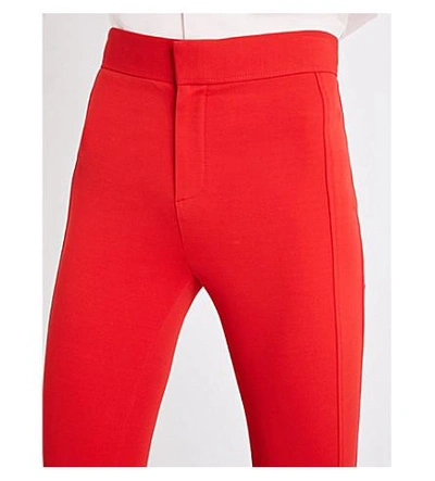 Shop Givenchy Flared Mid-rise Woven Trousers In Red