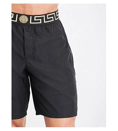 Shop Versace Iconic Long Swim Shorts In Black