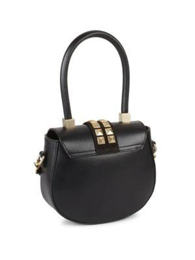 Shop Valentino Studded Leather Saddle Bag In Black