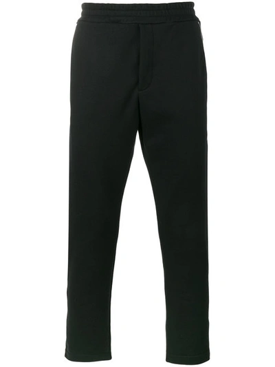 Alexander Mcqueen Zip Detailed Skull Patch Tapered Trousers In Black