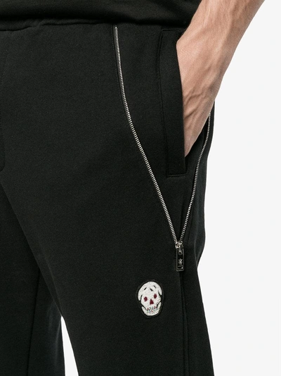 Shop Alexander Mcqueen Zip Detailed Skull Patch Tapered Trousers In Black